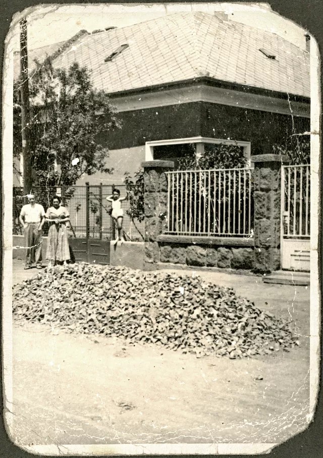The Molnars in front of their house