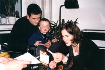 Ester, Daniel and Jakob Neutstadt lighting Chanukkah candles