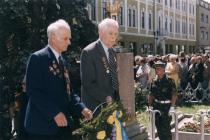 Mesko Nikolai in front of the memorial to the victims of World War II in Mukachevo